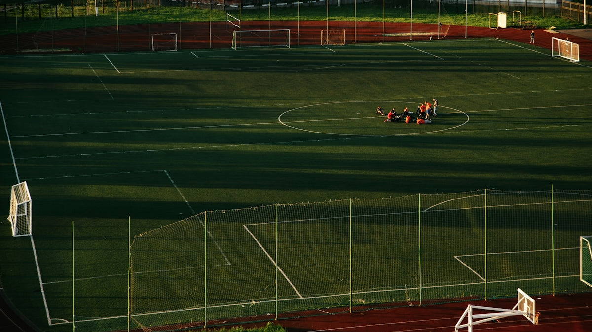 red and black sports car on track field