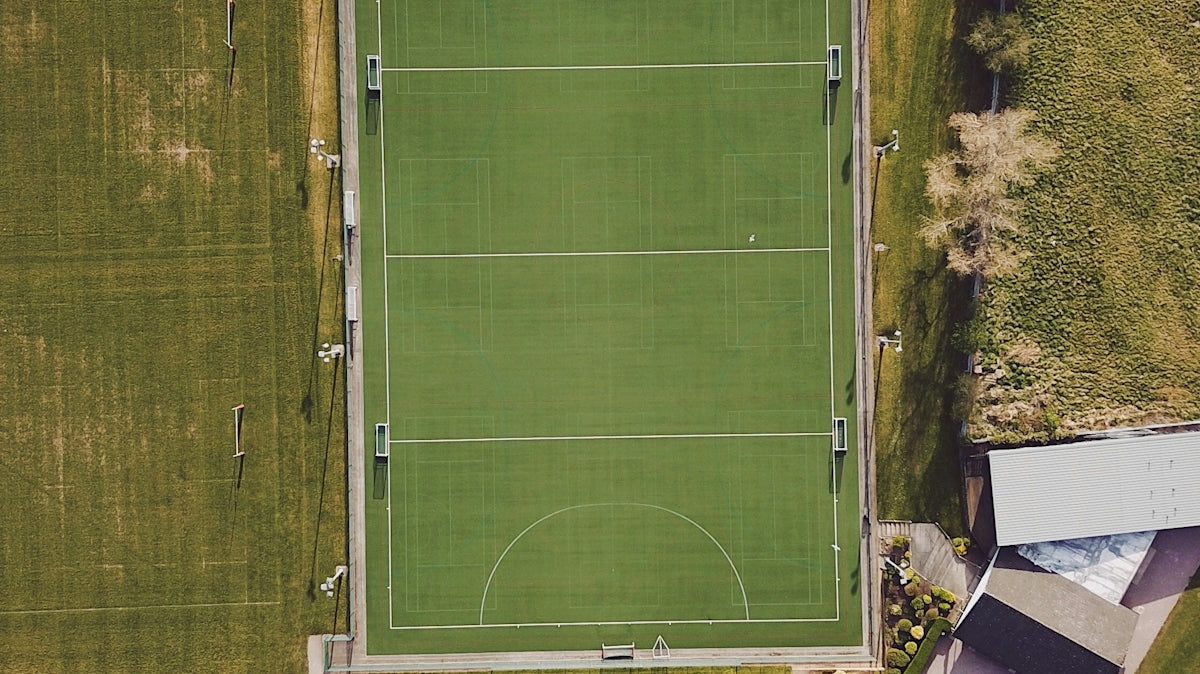 green and white solar panel on green grass field during daytime