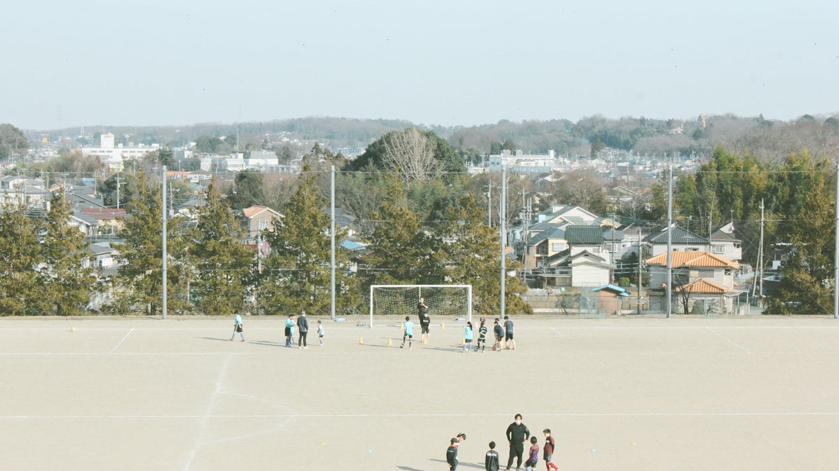 people playing ice hockey on field during daytime