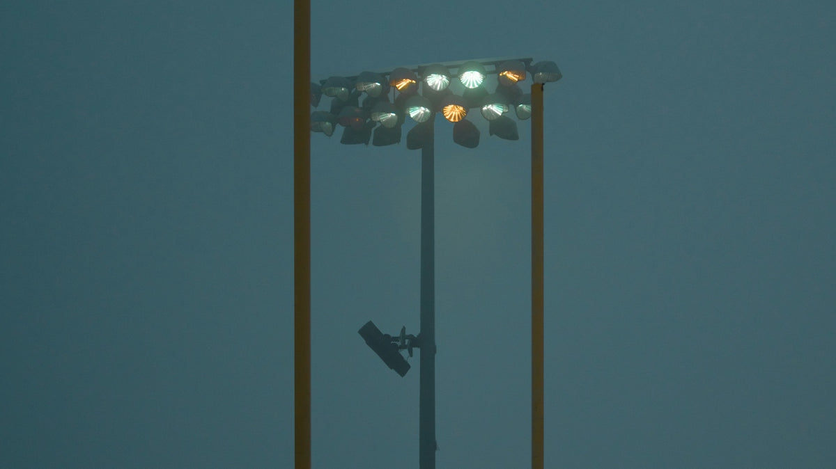a tall light pole with a street light on top of it