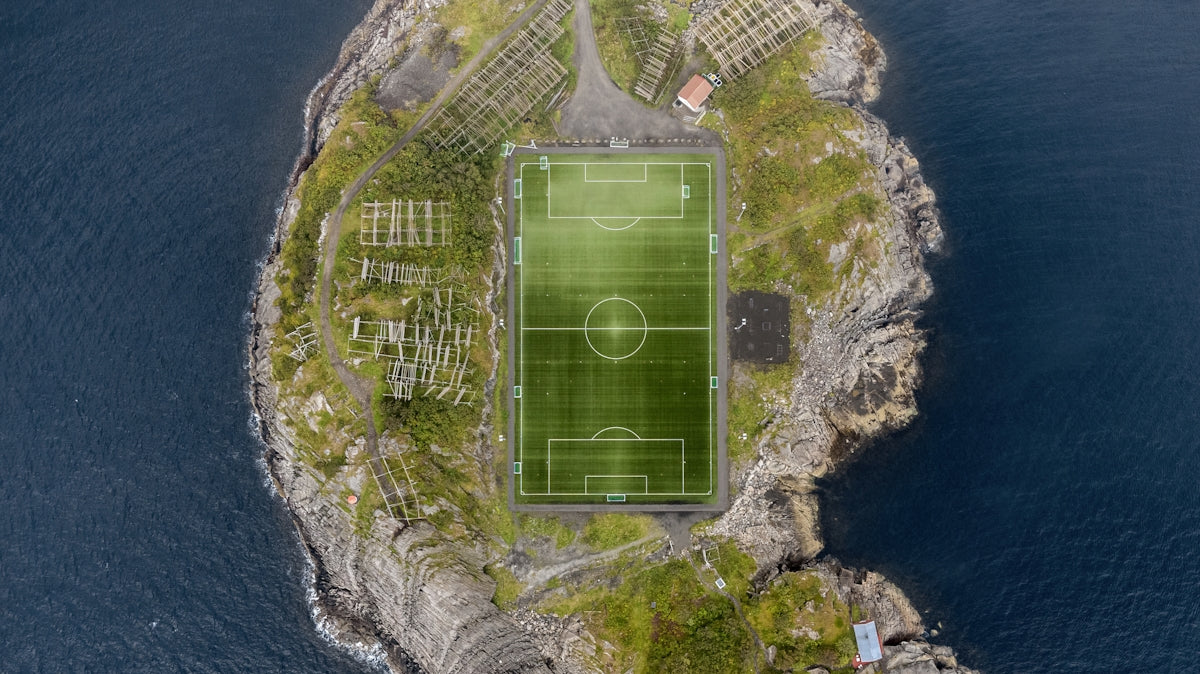 an aerial view of a soccer field on an island
