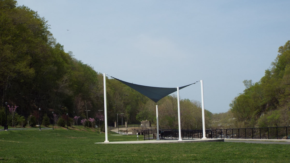 a grassy area with a structure in the back