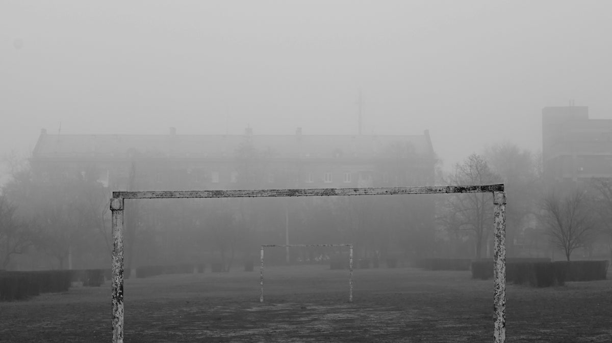 a black and white photo of a soccer goal