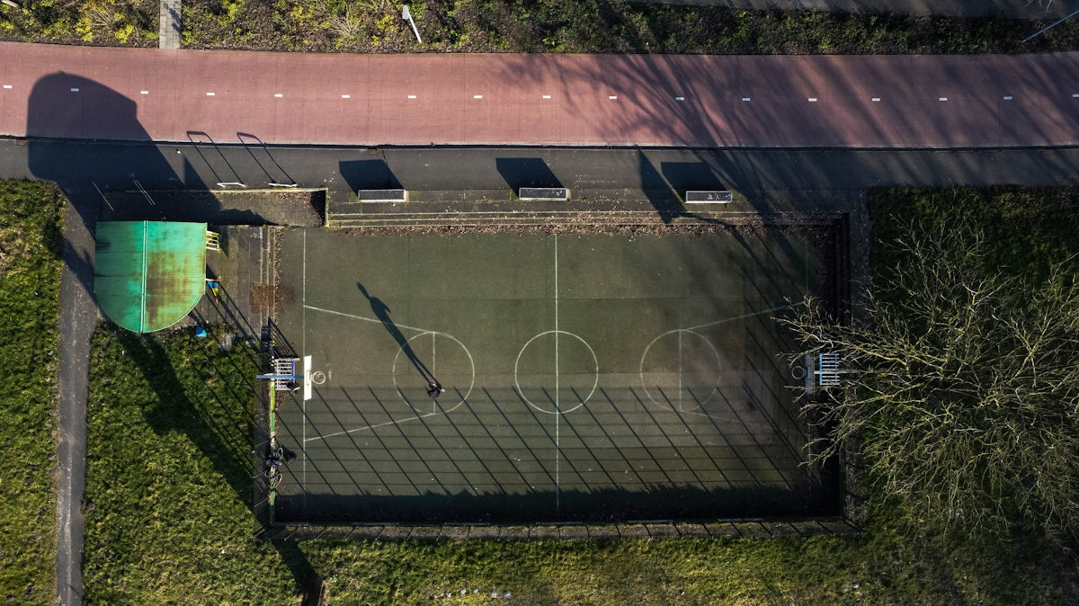 an aerial view of a basketball court in a park