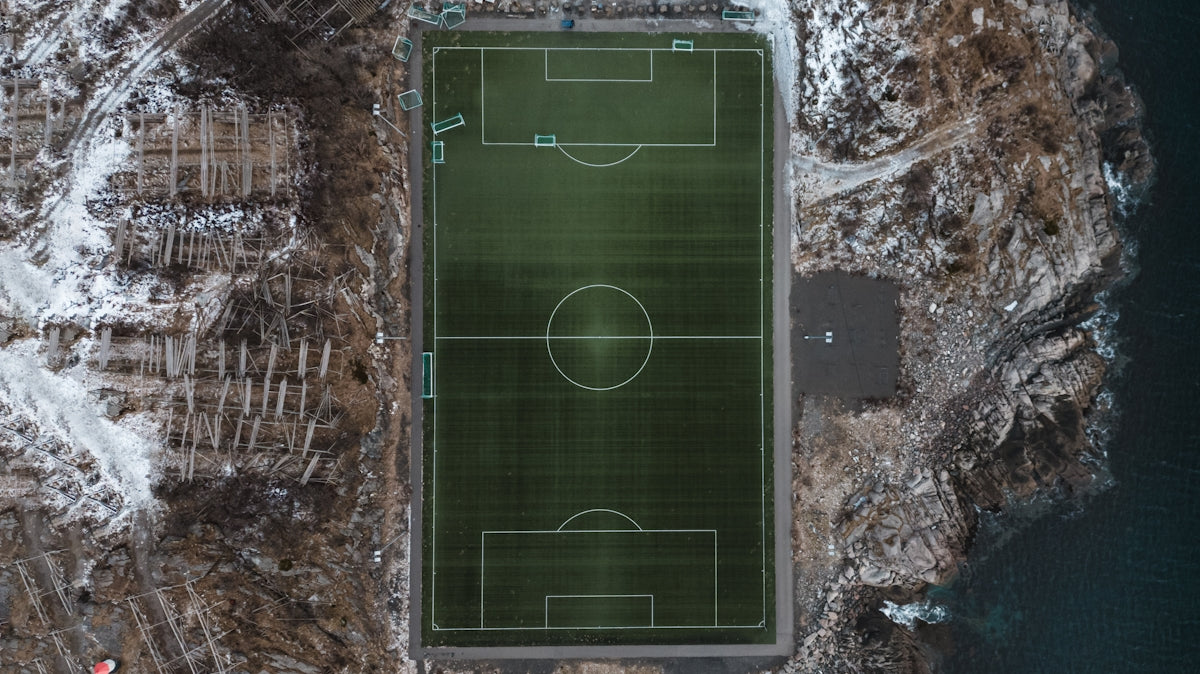 an aerial view of a soccer field in the snow