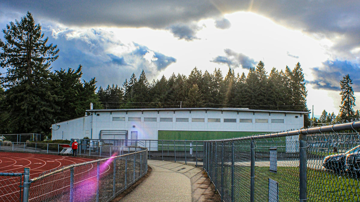 a tennis court with a tennis court in the background