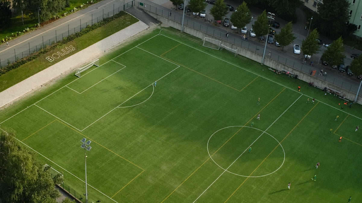 An aerial view of a soccer field in a city