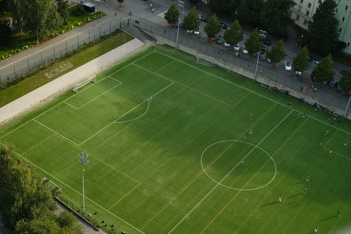 An aerial view of a soccer field in a city