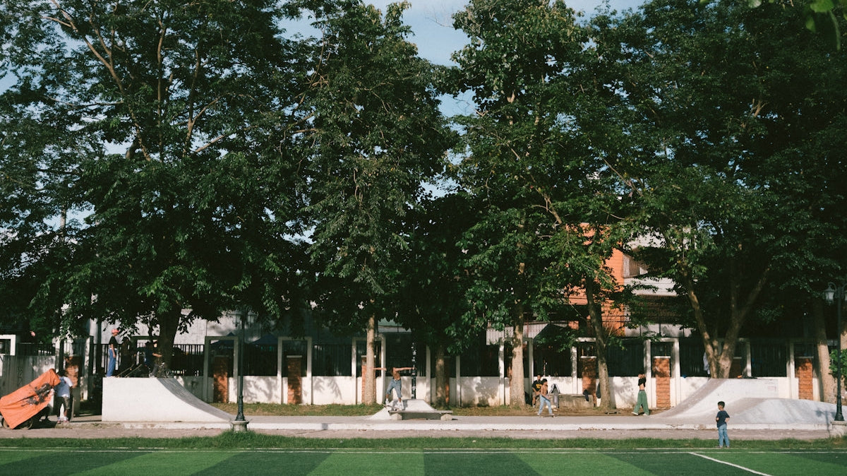 A soccer field in front of a large building