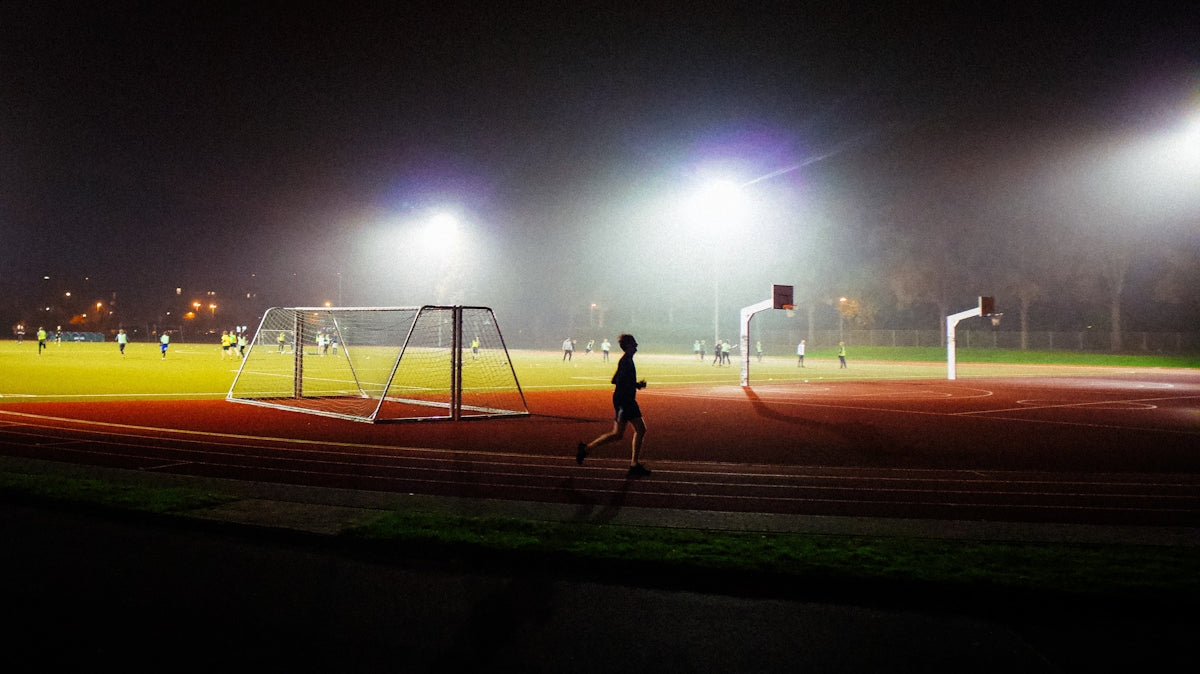A person running on a track at night