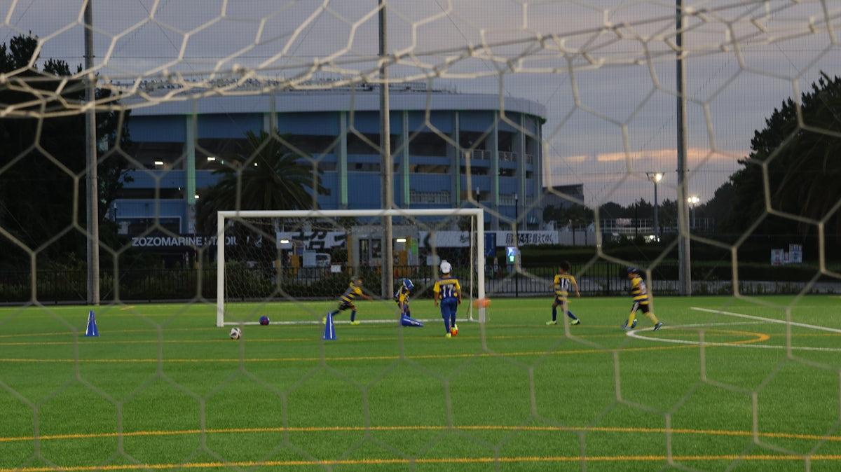 A group of people on a field playing soccer