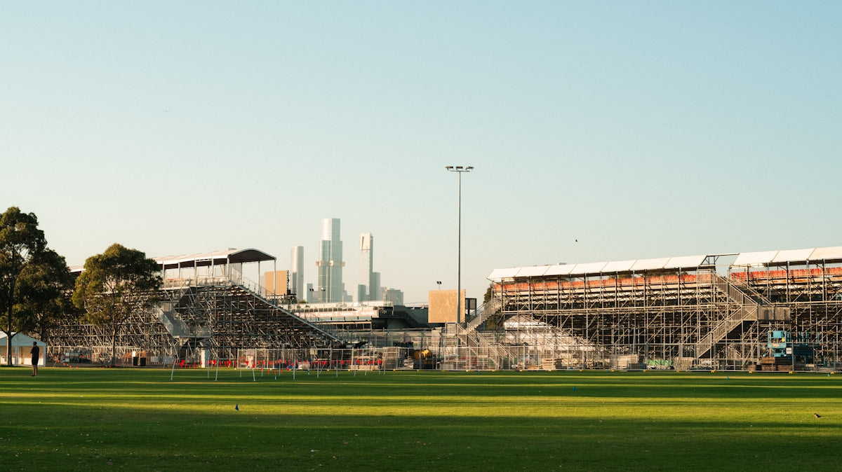 A soccer field with a stadium in the background