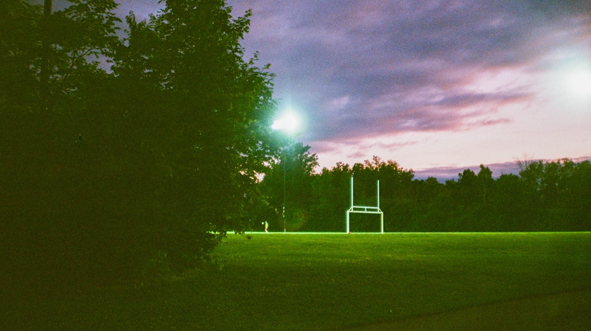 Football goalposts on a field at dusk