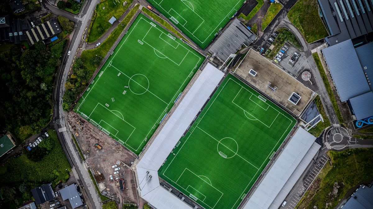 Aerial view of multiple green soccer fields.