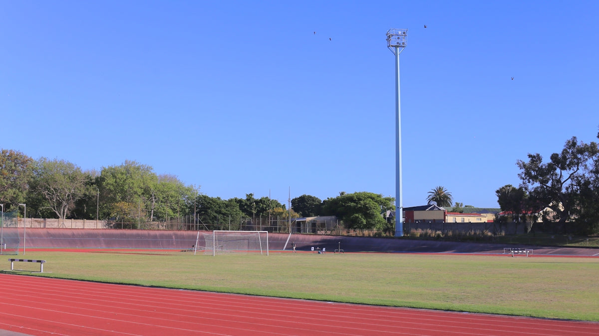 Running track and soccer field under clear blue sky