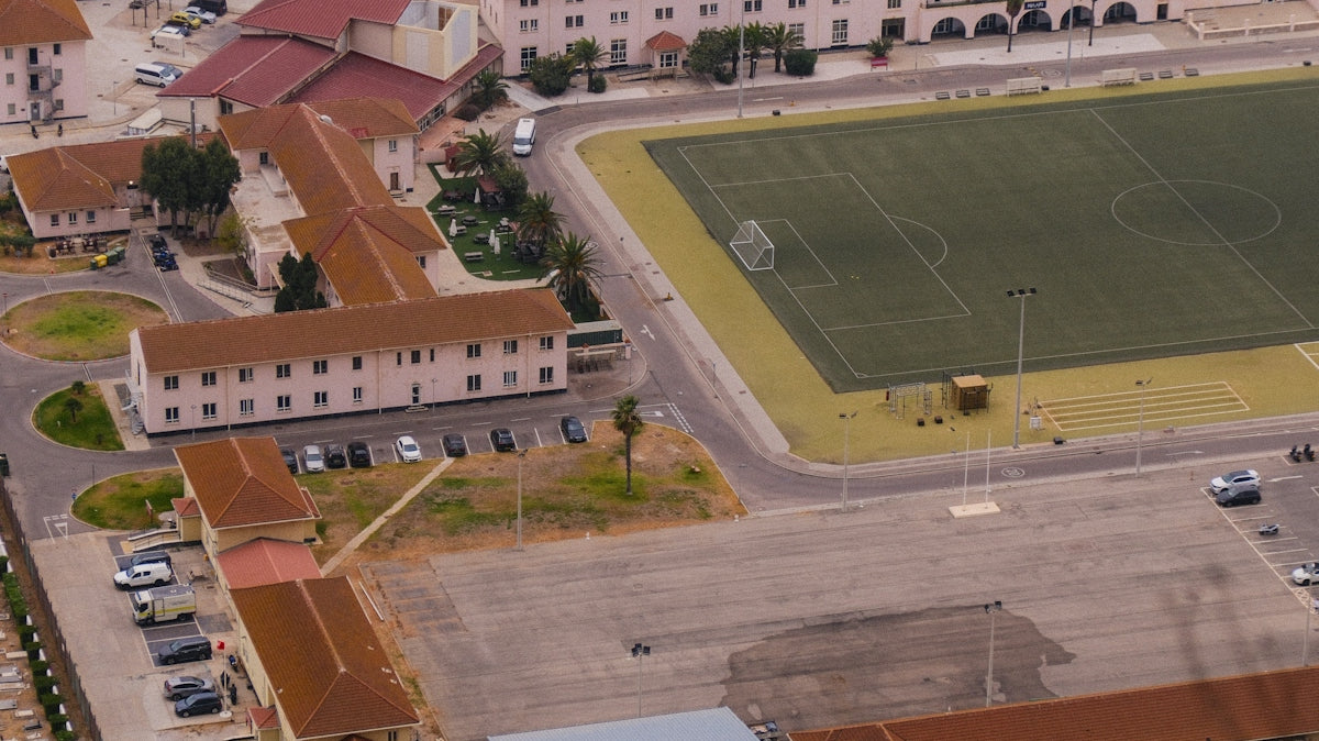 Aerial view of military barracks and sports field.