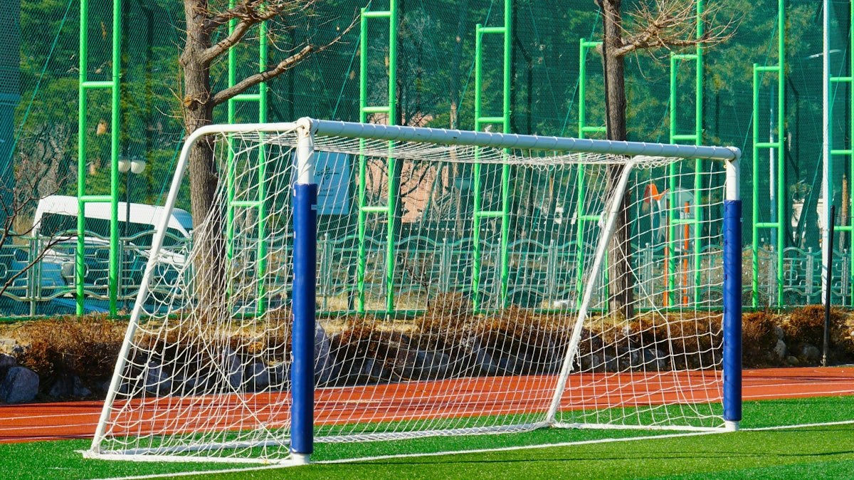 A white soccer goal on a green field