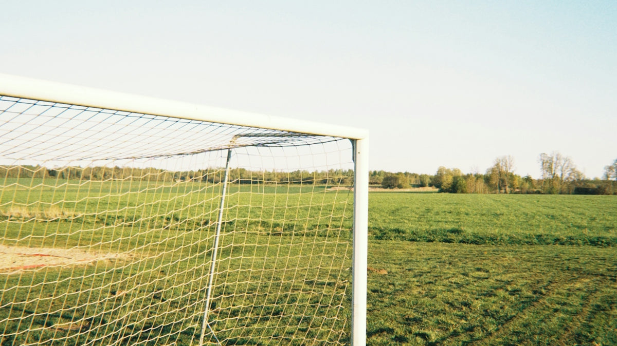 Soccer goal on a grassy field under a clear sky