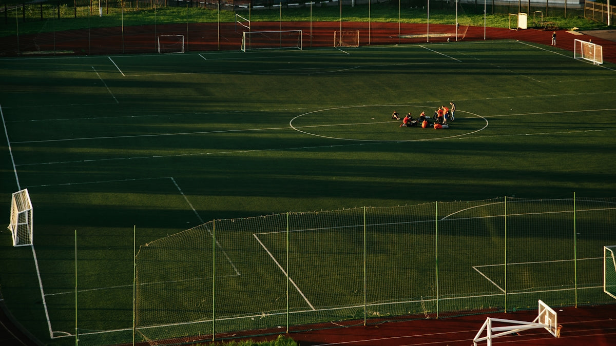 red and black sports car on track field