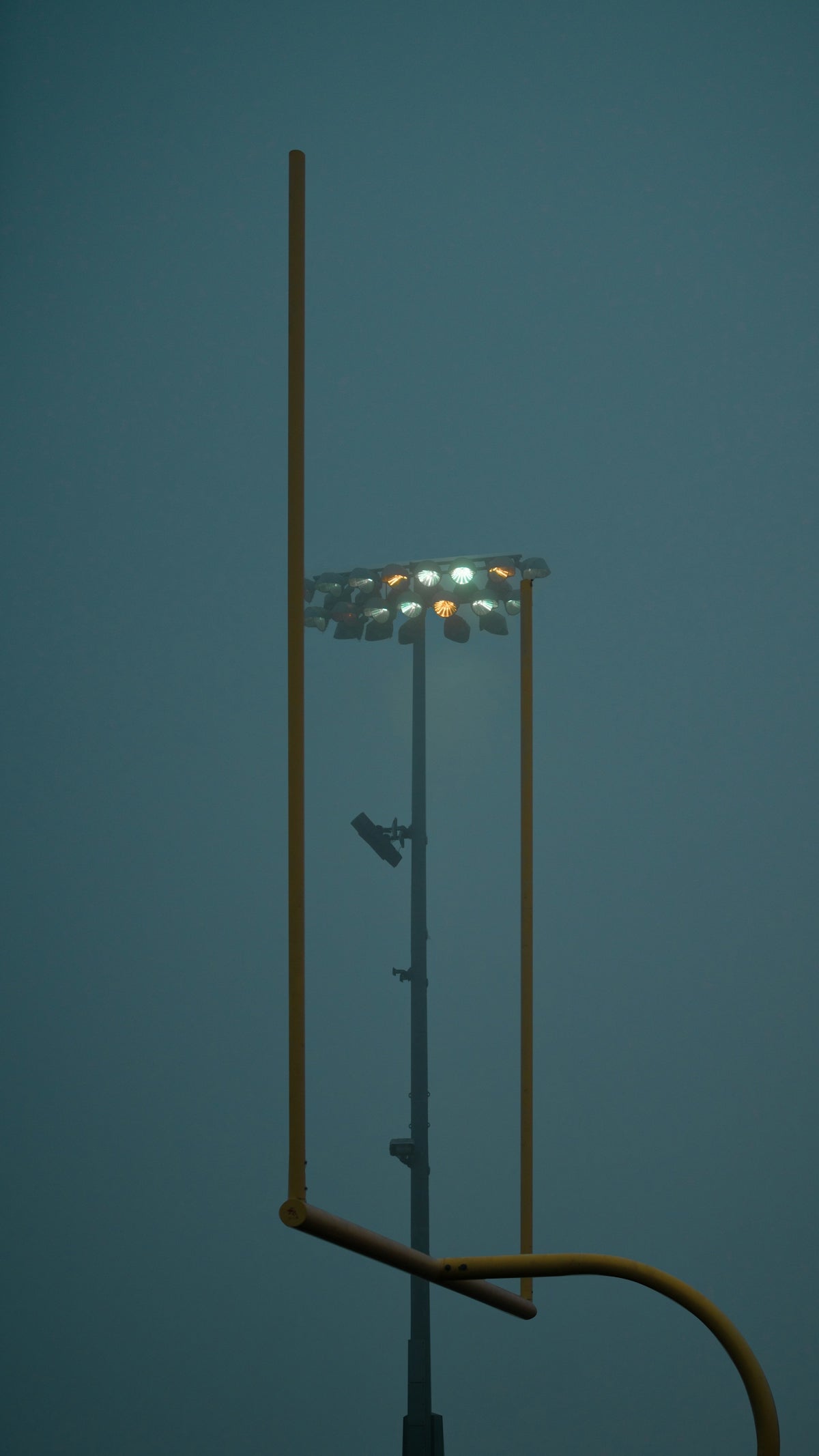 a tall light pole with a street light on top of it