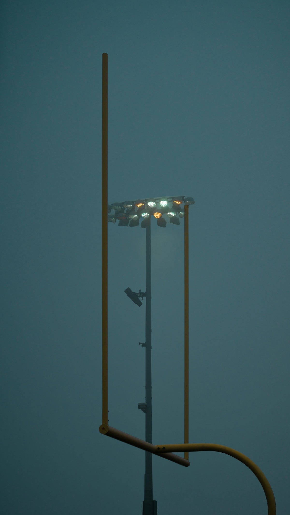 a tall light pole with a street light on top of it