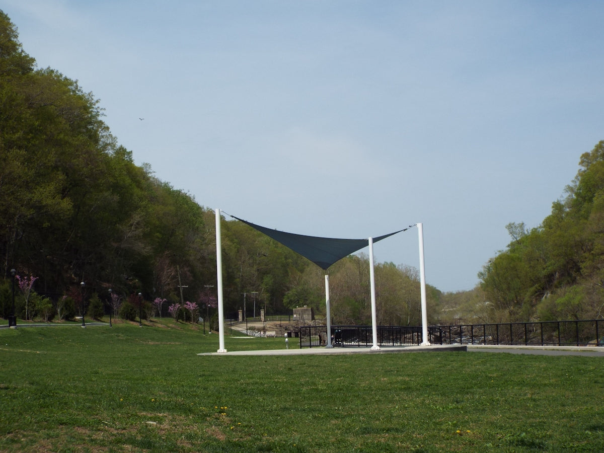 a grassy area with a structure in the back