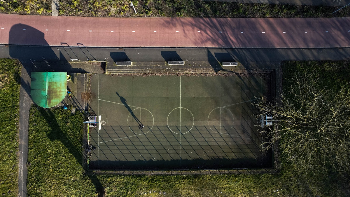 an aerial view of a basketball court in a park