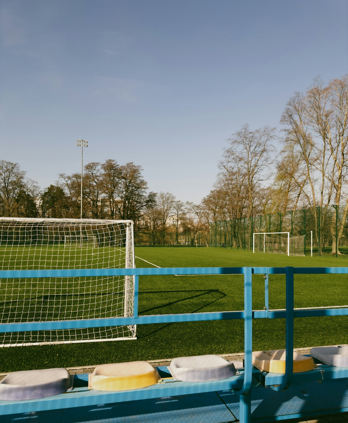 a soccer field with a goal in the background