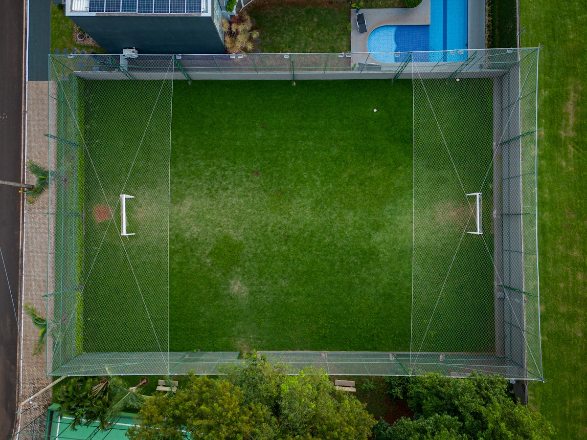 an aerial view of a green soccer field