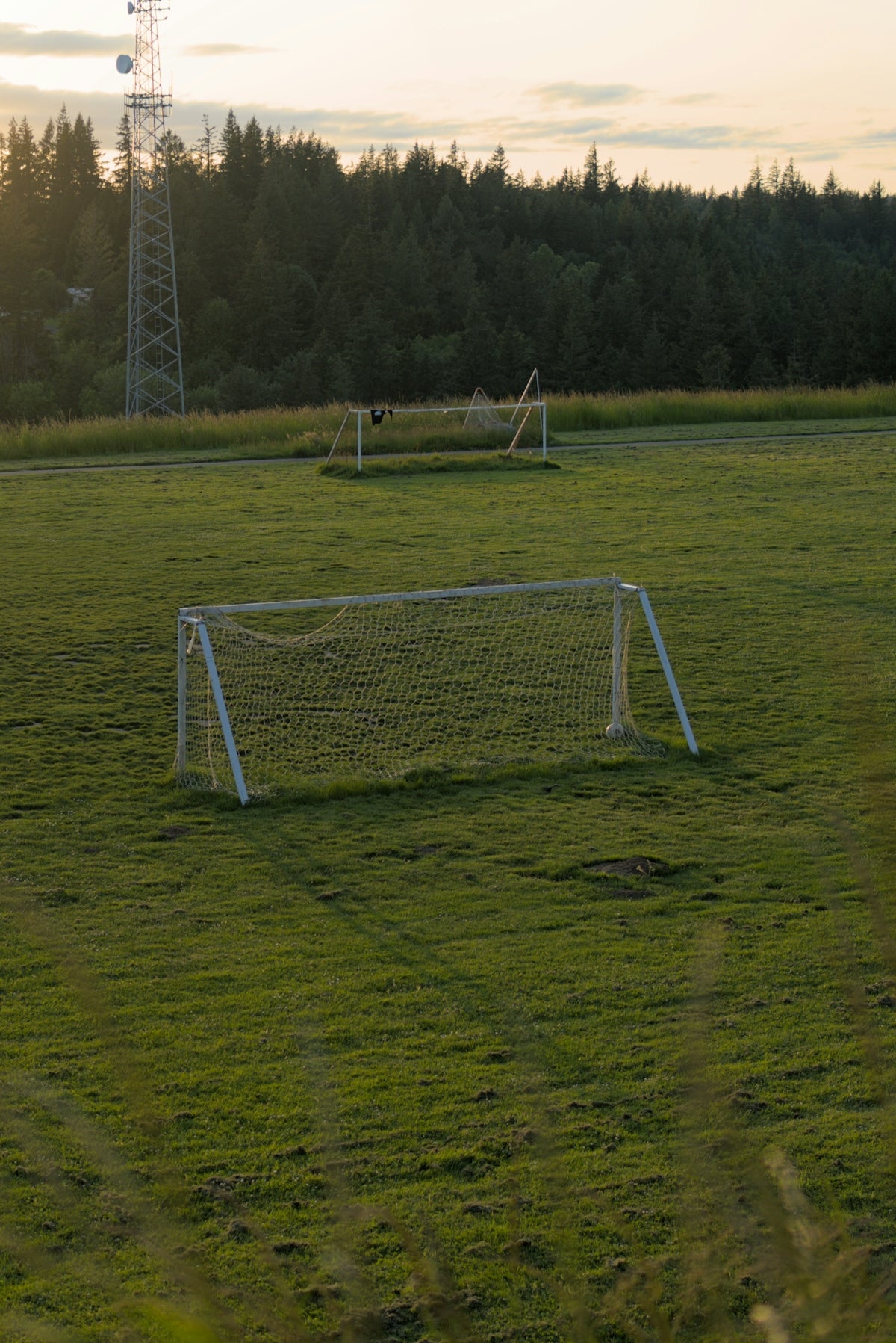 a soccer field with a soccer goal and a soccer ball