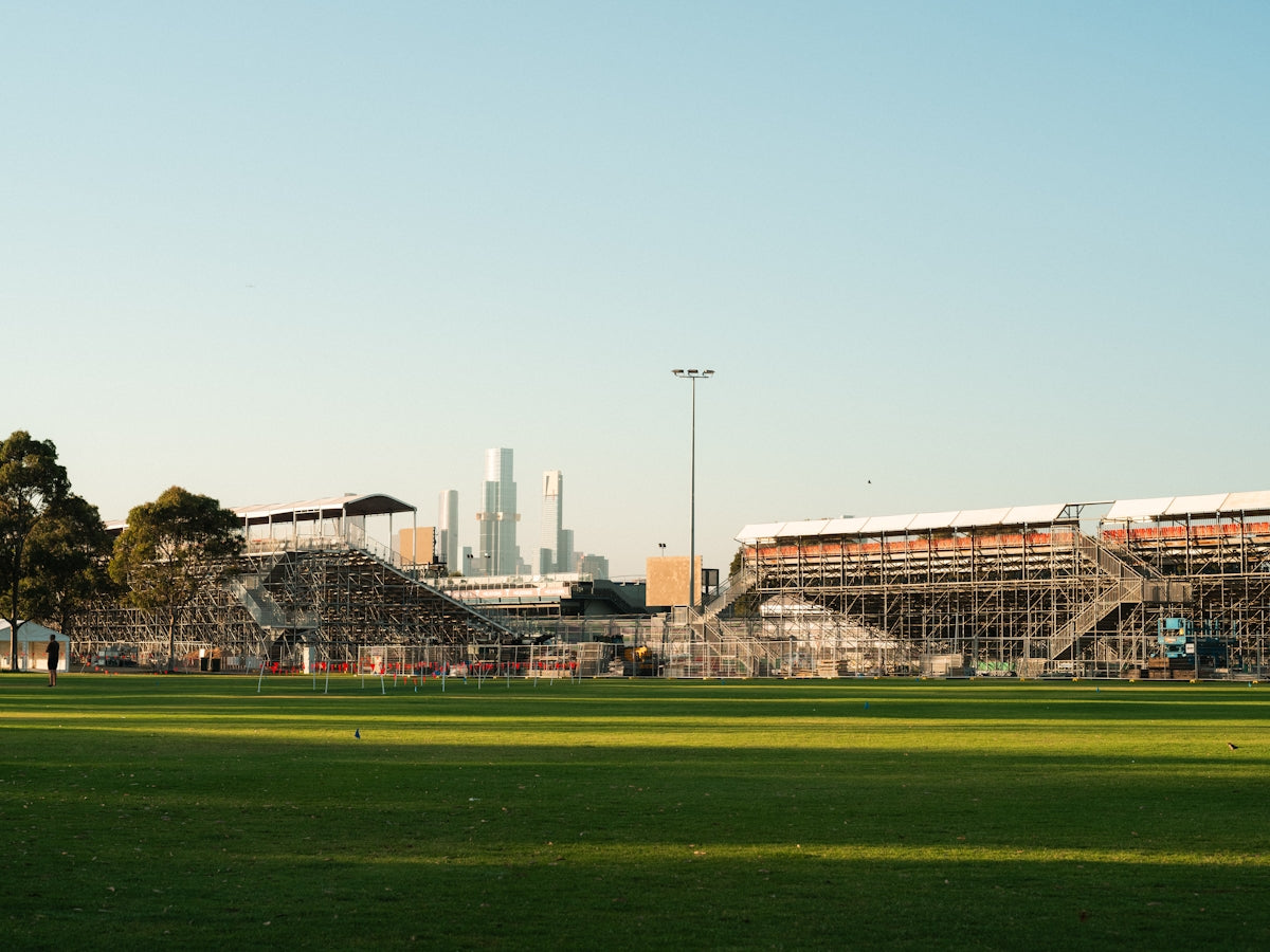 A soccer field with a stadium in the background