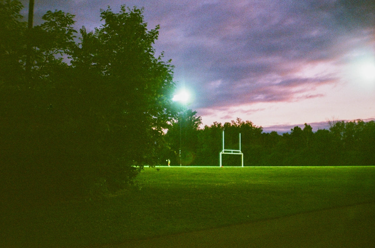 Football goalposts on a field at dusk