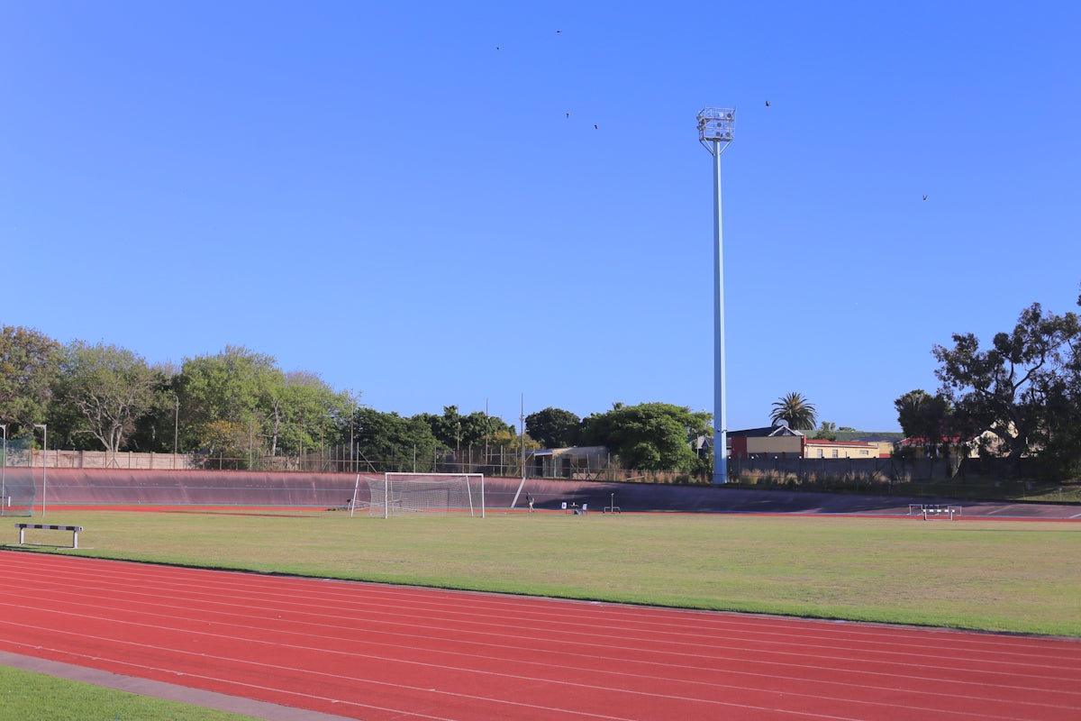 Running track and soccer field under clear blue sky
